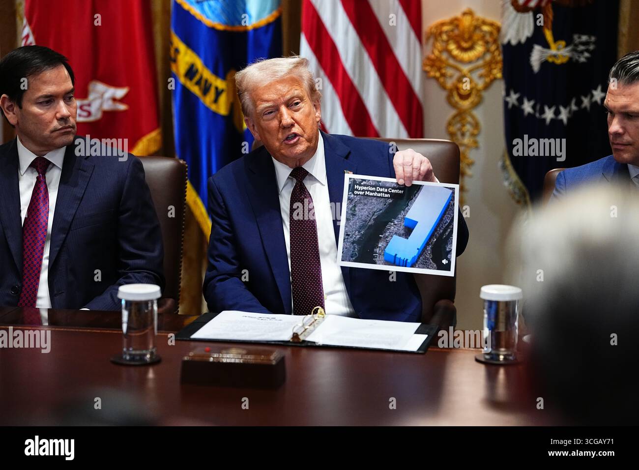 Washington, États-Unis d'Amérique. 26 août 2025. Le président américain Donald J Trump affiche un graphique comparant la taille d'un centre de données par rapport à l'île de Manhattan alors qu'il préside une réunion du Cabinet dans la salle du Cabinet de la Maison Blanche à Washington, DC, USA, le mardi 26 août, 2025. en regardant de gauche à droite, le Secrétaire d'État américain Marco Rubio Credit : Aaron Schwartz/Pool via CNP/AdMedia/Newscom/Alamy Live News Banque D'Images