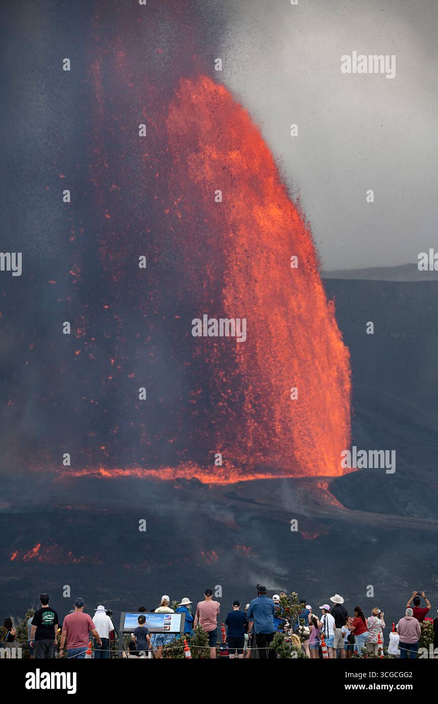 Les visiteurs se rassemblent à un point de vue pour admirer des fontaines de lave chaude qui montent à 1000 mètres du cratère Halemaumau, volcan Kilauea, HVNP, île d'Hawaï, États-Unis Banque D'Images