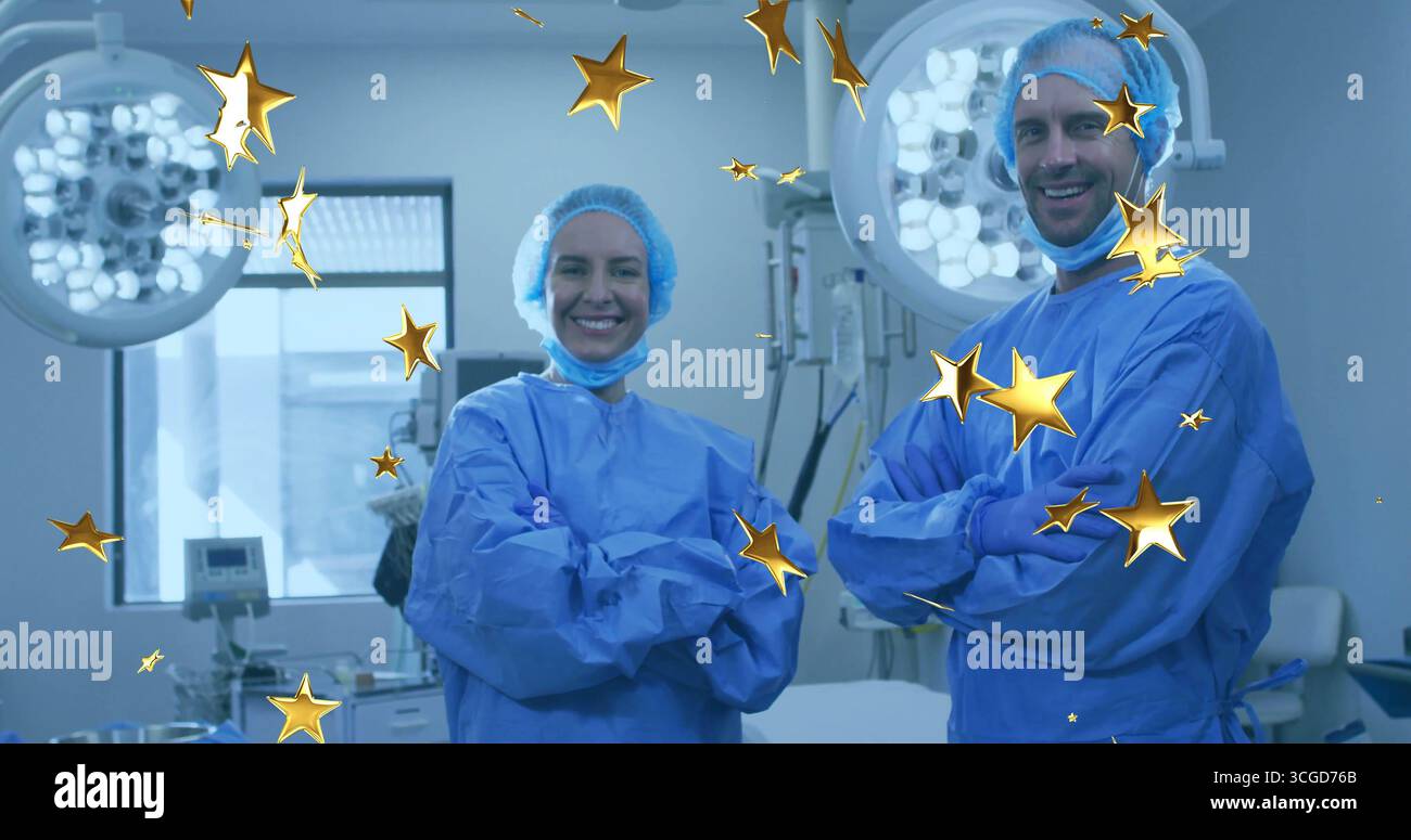 Chirurgiens debout portant des blouses dans la suite chirurgicale, avec des lumières chirurgicales, moniteur et étoiles d'or Banque D'Images