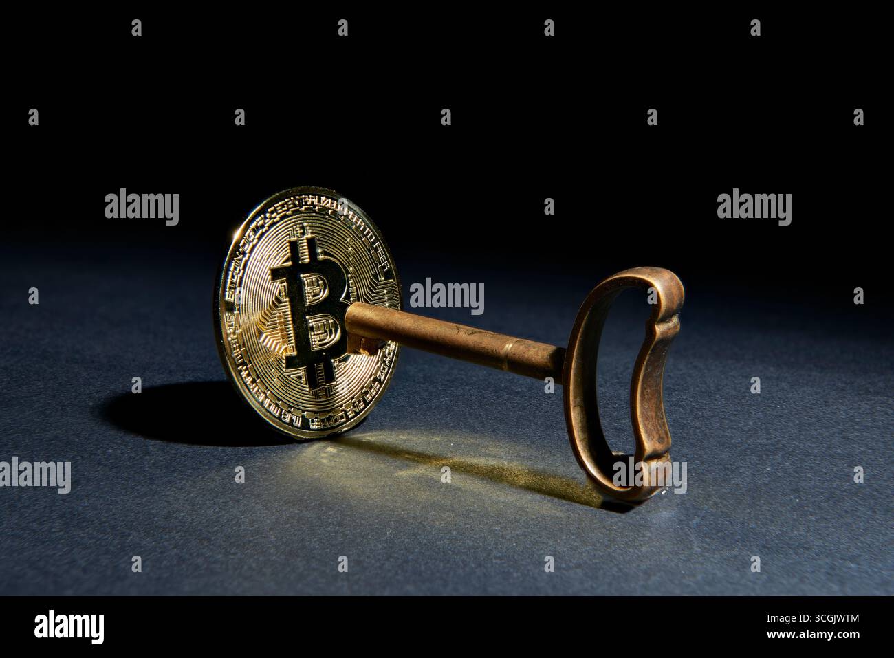 Un Bitcoin physique avec une vieille clé, symbolisant la clé privée d'un portefeuille crypto. Une image conceptuelle pour la sécurité blockchain, la propriété numérique, fi Banque D'Images