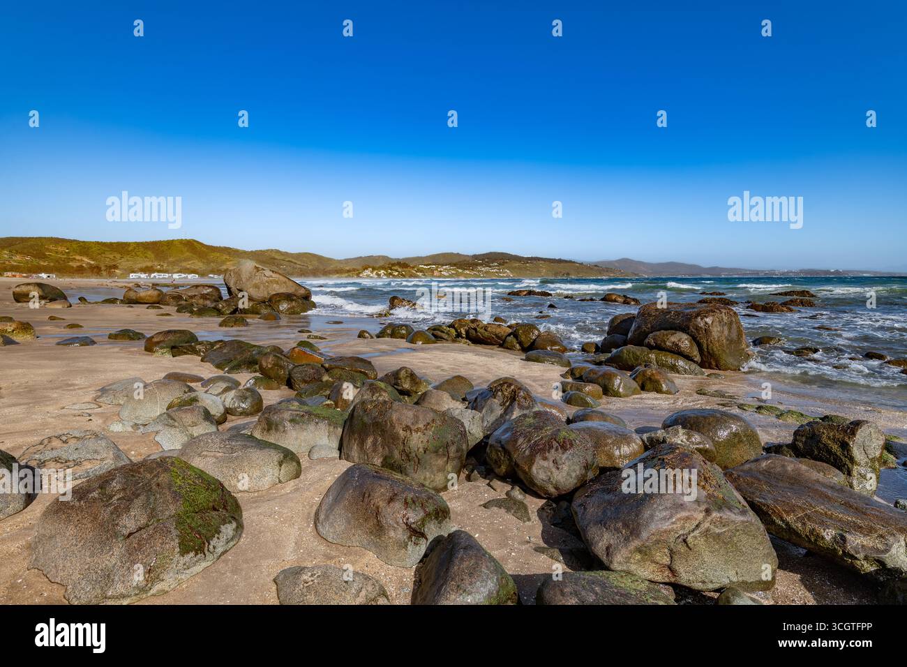 Le paysage côtier serein de Cachagua, Chili, avec de grands rochers sur le sable et l'océan Pacifique. Banque D'Images