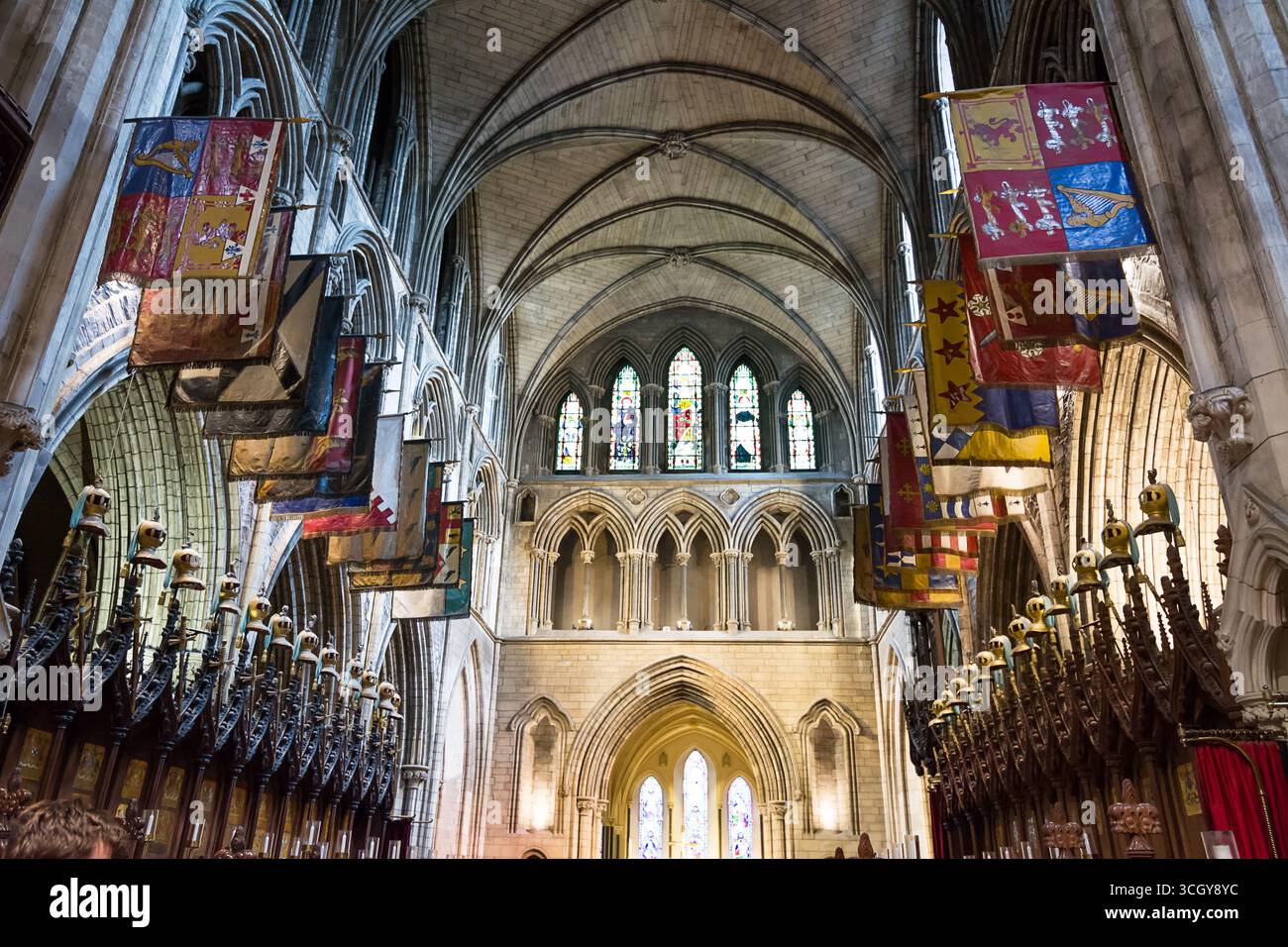 Intérieur de la cathédrale St Patricks à Dublin Irlande avec des plafonds voûtés et des drapeaux colorés décorant l'église historique Banque D'Images