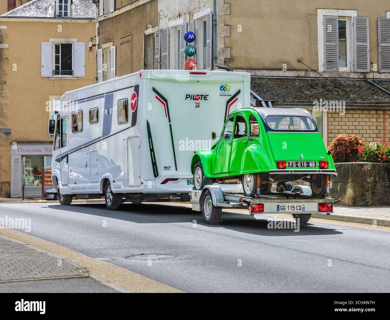 Pilote camping car remorquant une Citroën 2CV sur une remorque (attelant un véhicule) - Neuvy-Saint-Sépulchre, Indre (36), France. Banque D'Images