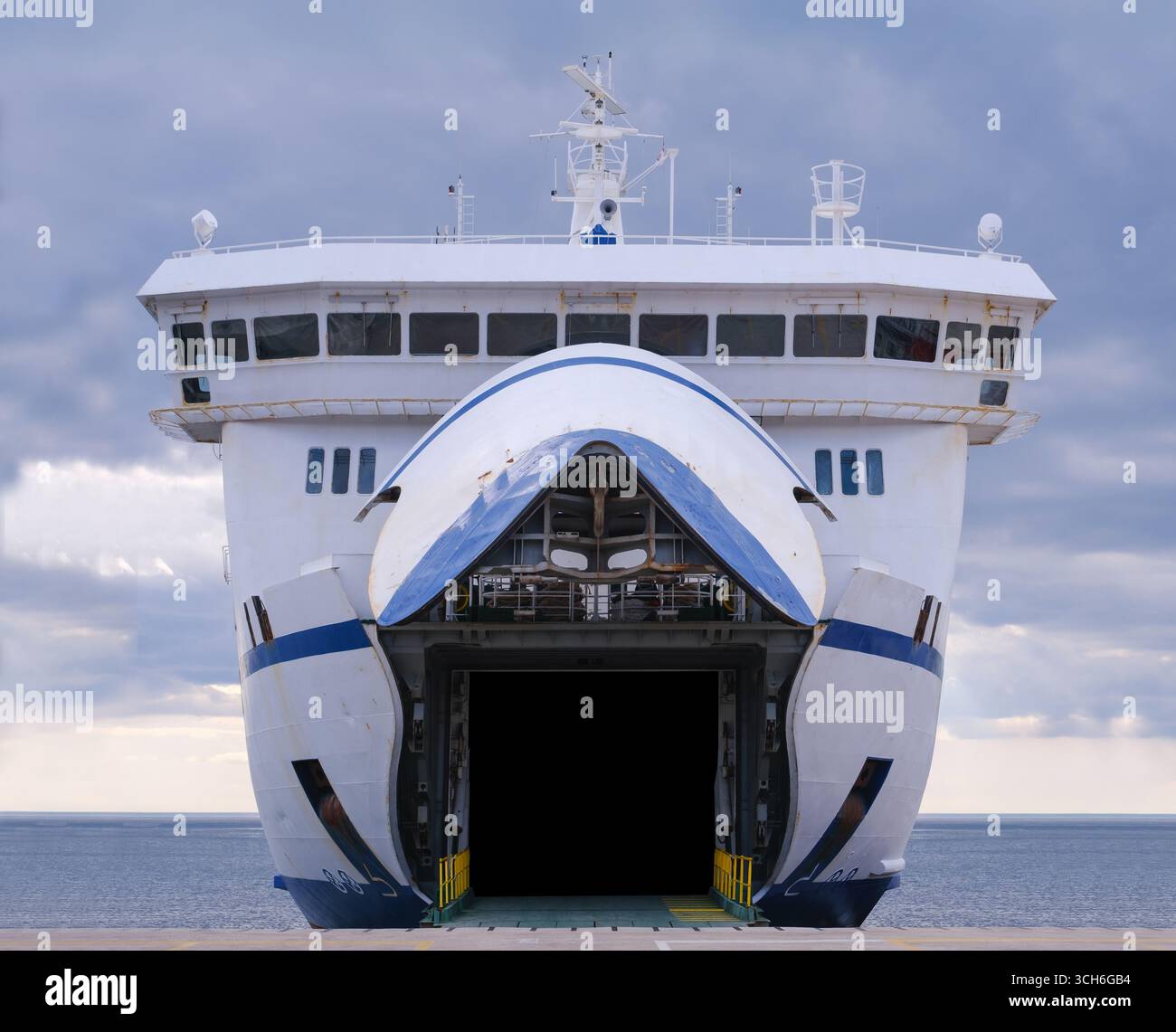Vue de face d'Un grand Roll-on Roll-Off Ferry (Ro-Ro Ship) amarré au port avec sa porte d'arc ouverte pour les véhicules et les passagers, le transport maritime et TR Banque D'Images