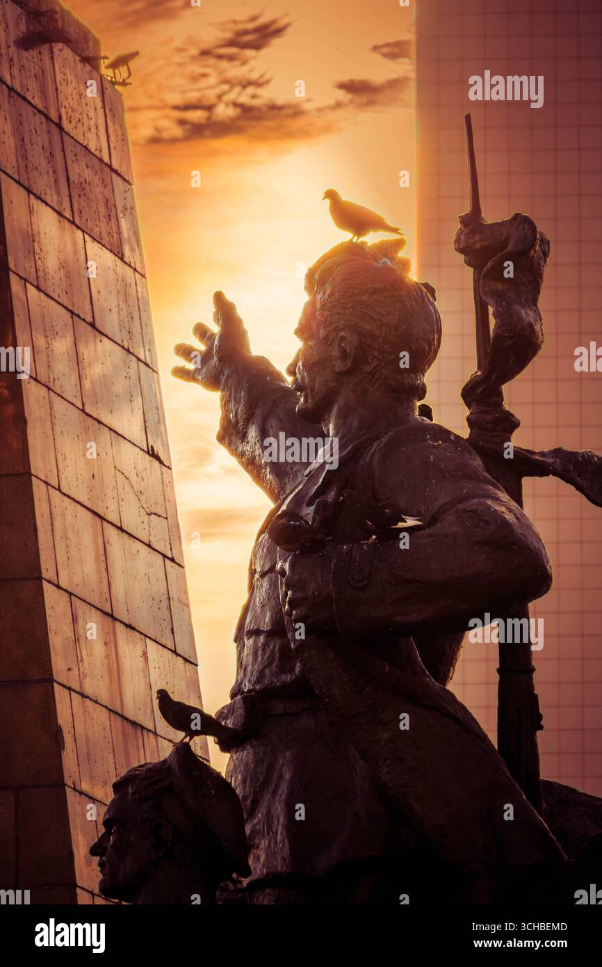 Monument aux combattants pour le pouvoir soviétique sur la place centrale de Vladivostok, Russie, statues en bronze contre la lumière dramatique du coucher du soleil (photo verticale). Banque D'Images