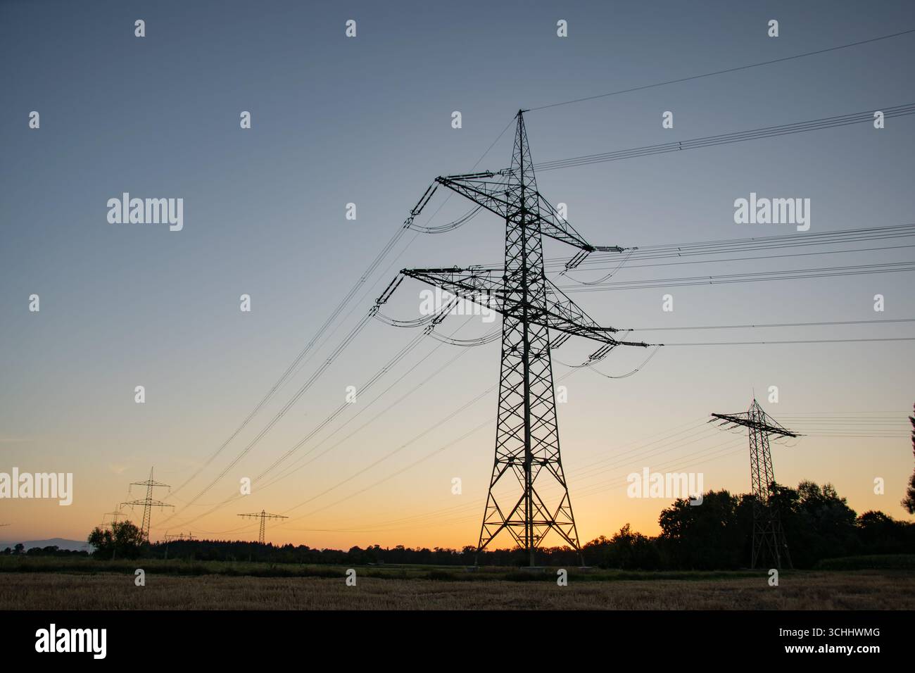 Pylône électrique à haute tension photographié d'en bas à l'heure bleue peu après le coucher du soleil, silhouetté contre le ciel du soir en Allemagne. Banque D'Images Pylône électrique à haute tension photographié d'en bas à l'heure bleue peu après le coucher du soleil, silhouetté contre le ciel du soir en Allemagne. Banque D'Images