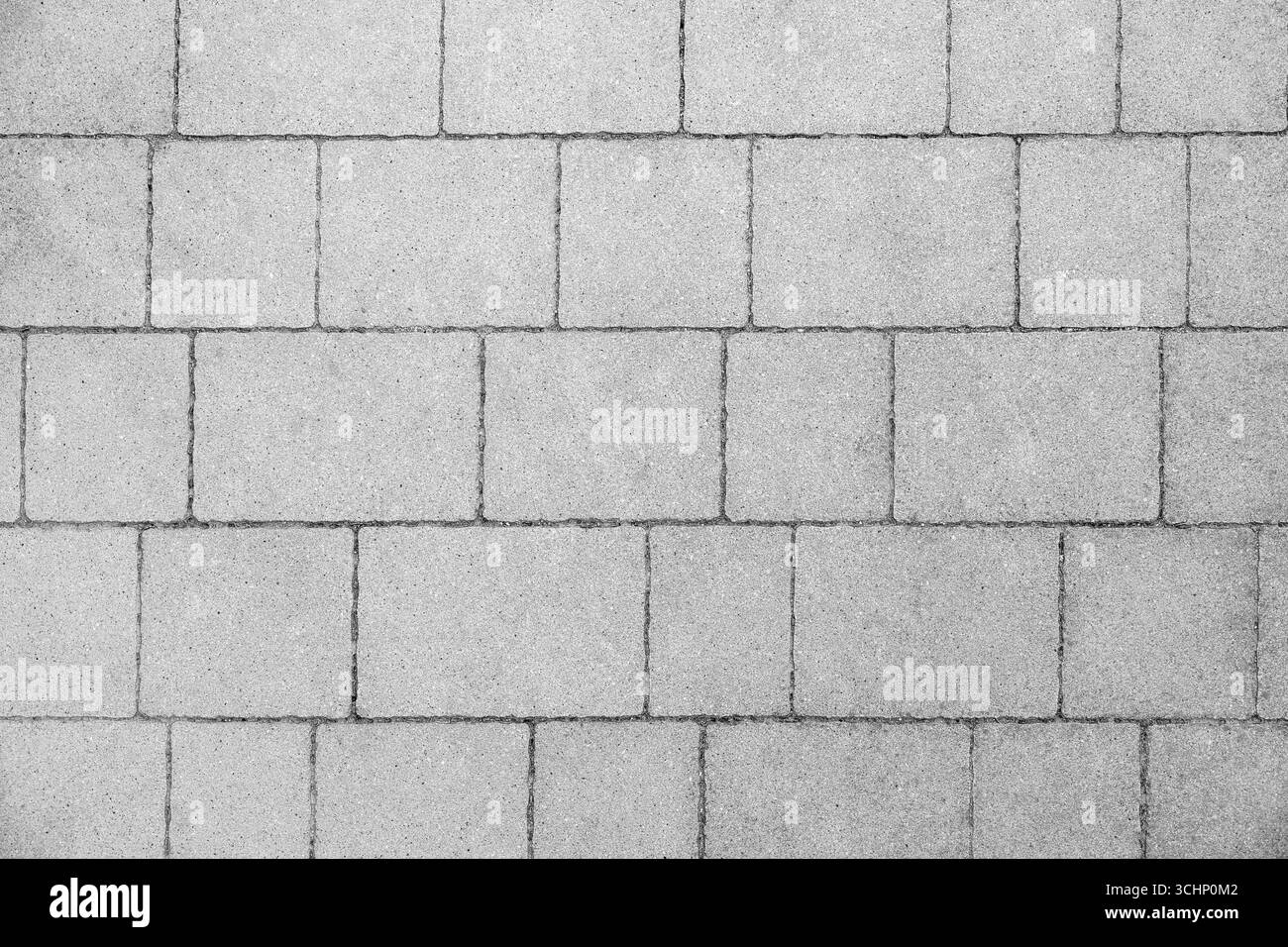 Carreaux de pavement en béton gris disposés dans un motif géométrique, vue de dessus de la surface de pavage moderne pour la conception urbaine et résidentielle Banque D'Images