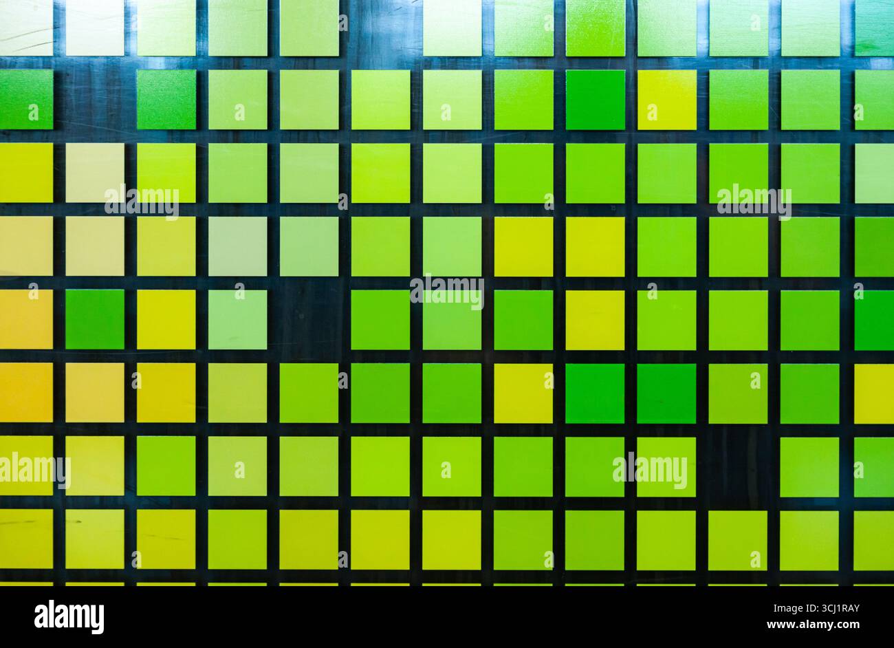 Mosaïque de petits carrés vert-jaune sur verre, gros plan. Carrés numériques de style matriciel. Banque D'Images