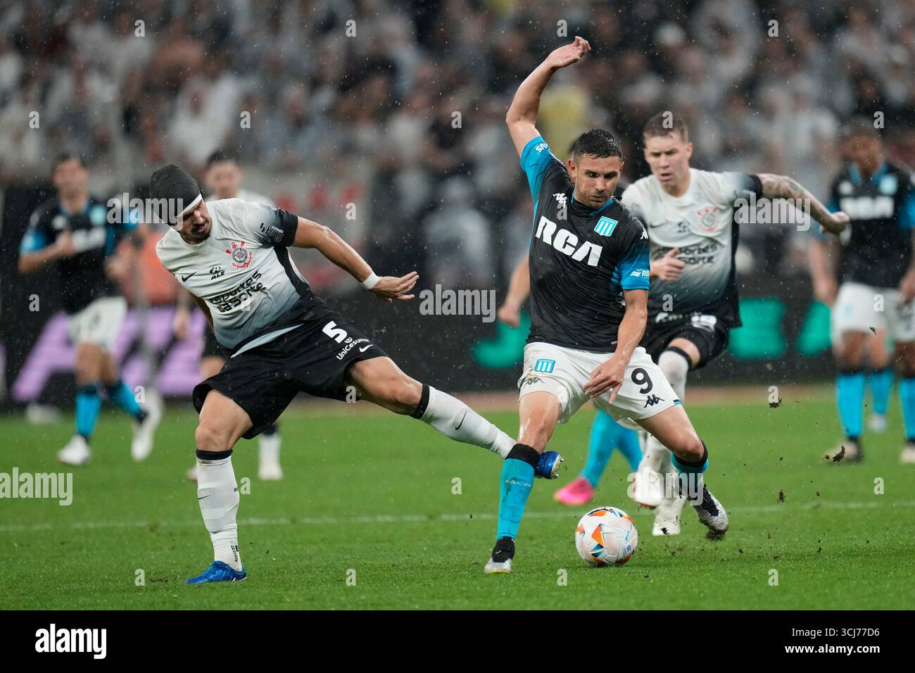 FILE - Andre Ramalho of Brazil's Corinthians, left, and Adrian Martinez of Argentina's Racing Club battle for the ball during a Copa Sudamericana semifinal first leg soccer match at Neo Quimica arena in Sao Paulo, Oct. 24, 2024. (AP Photo/Andre Penner, File) Banque D'Images