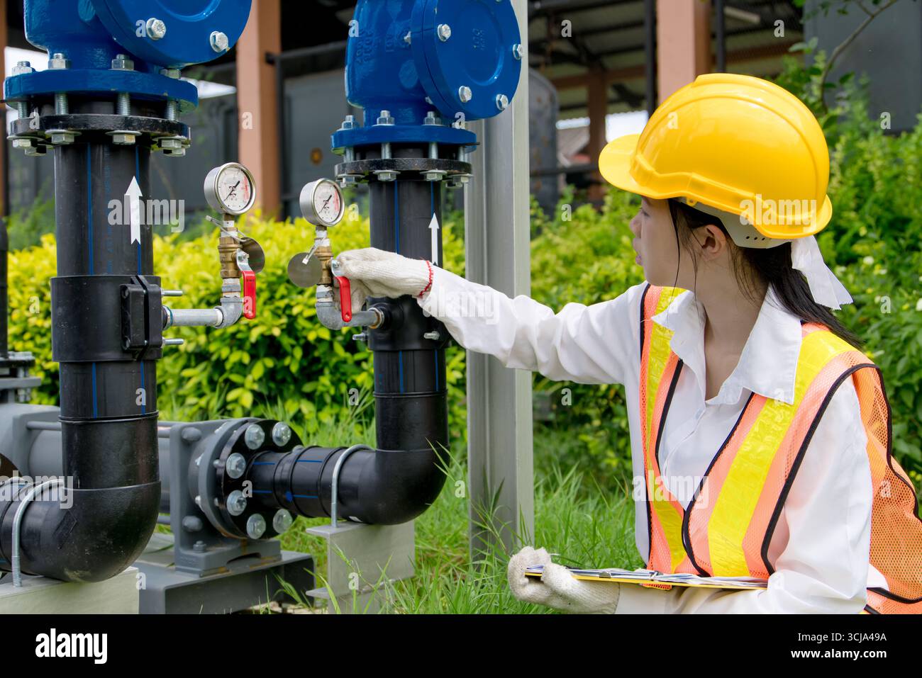 Le travail sur le terrain de technicien d'ingénieur vérifie la nouvelle installation des pompes à cavité progressive avec le système de tuyau de vanne d'eau haute pression à l'extérieur Banque D'Images