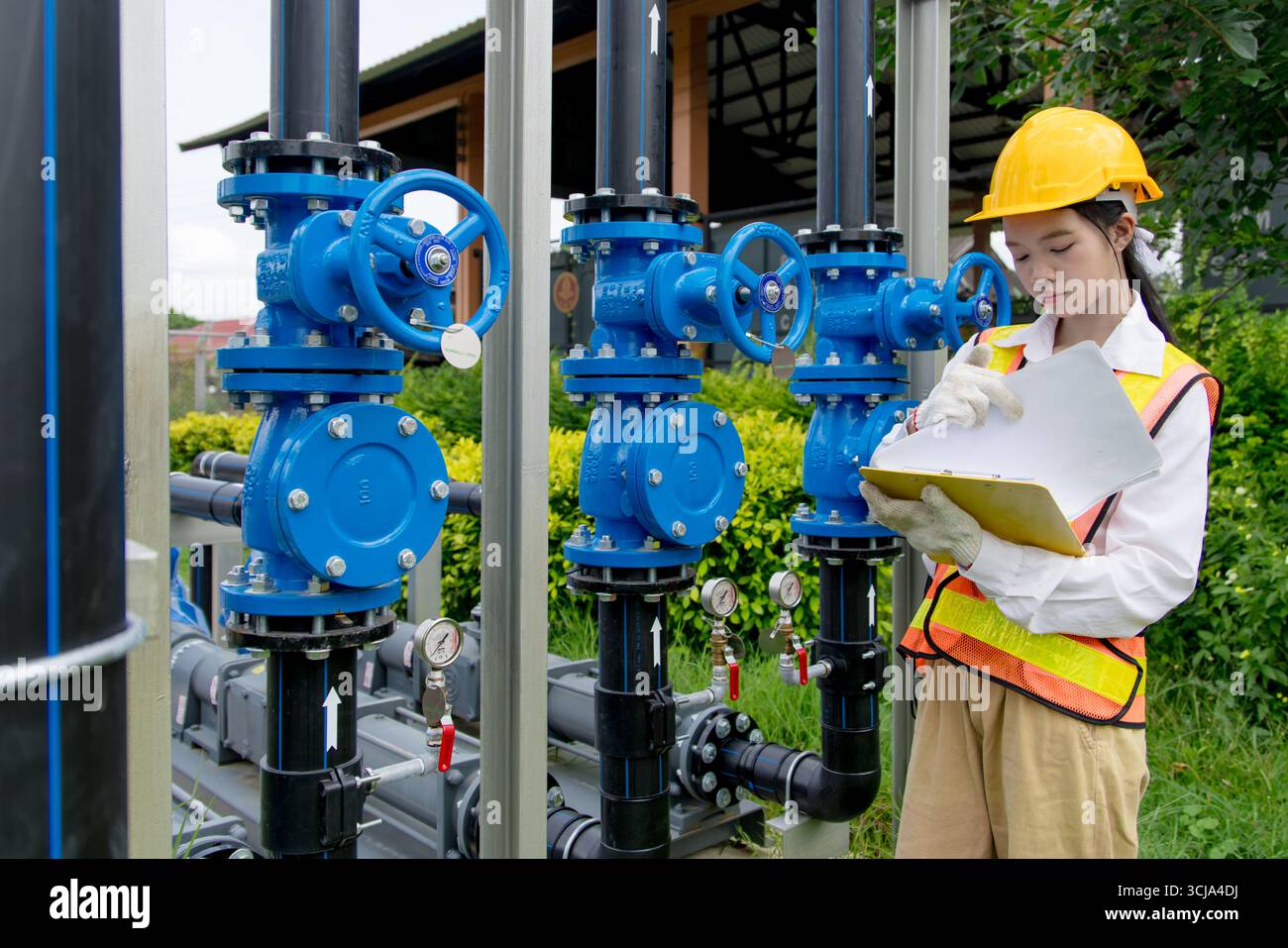 Le travail sur le terrain de technicien d'ingénieur vérifie la nouvelle installation des pompes à cavité progressive avec le système de tuyau de vanne d'eau haute pression à l'extérieur Banque D'Images