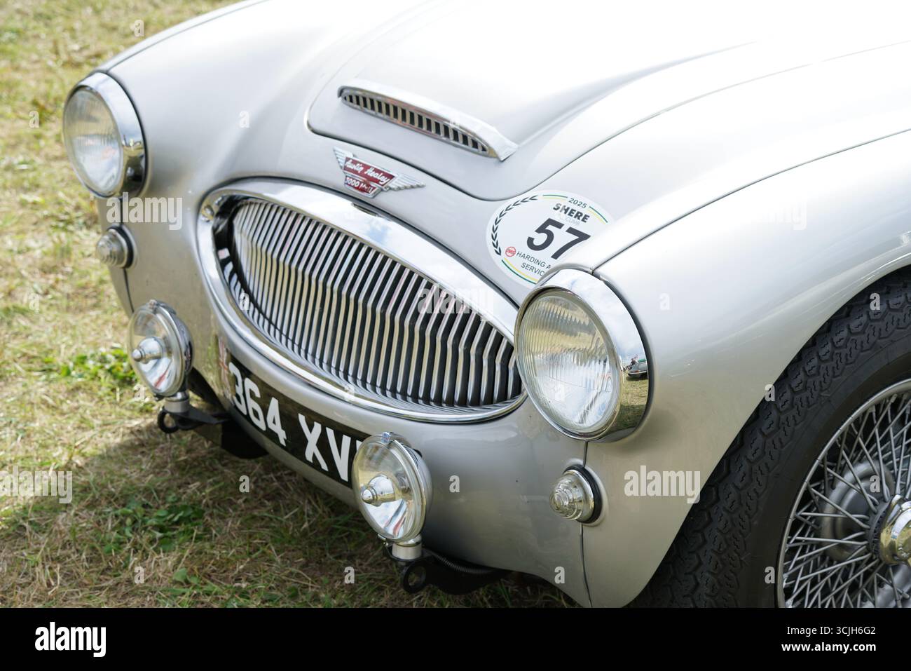 Vue rapprochée de l'avant d'une voiture sport classique argentée avec calandre de radiateur et phares. Shere Hill Climb, East Clandon, Guildford Banque D'Images