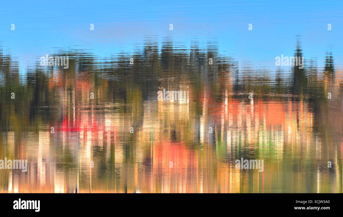 Paysage reflété dans l'estuaire. La distorsion causée par l'eau en mouvement et les couleurs vives lui donnent l'apparence d'une peinture impressionniste. Banque D'Images