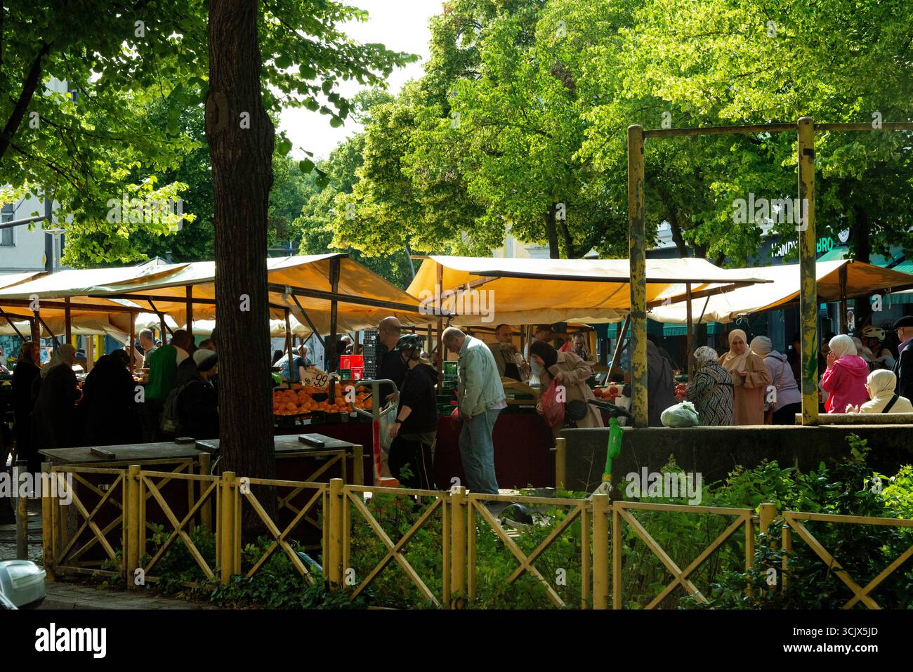 Une scène vivante et authentique dans un marché en plein air animé dans le quartier de Rixdorf à Berlin, en Allemagne. Par une journée lumineuse et ensoleillée, une foule diversifiée de s. Banque D'Images