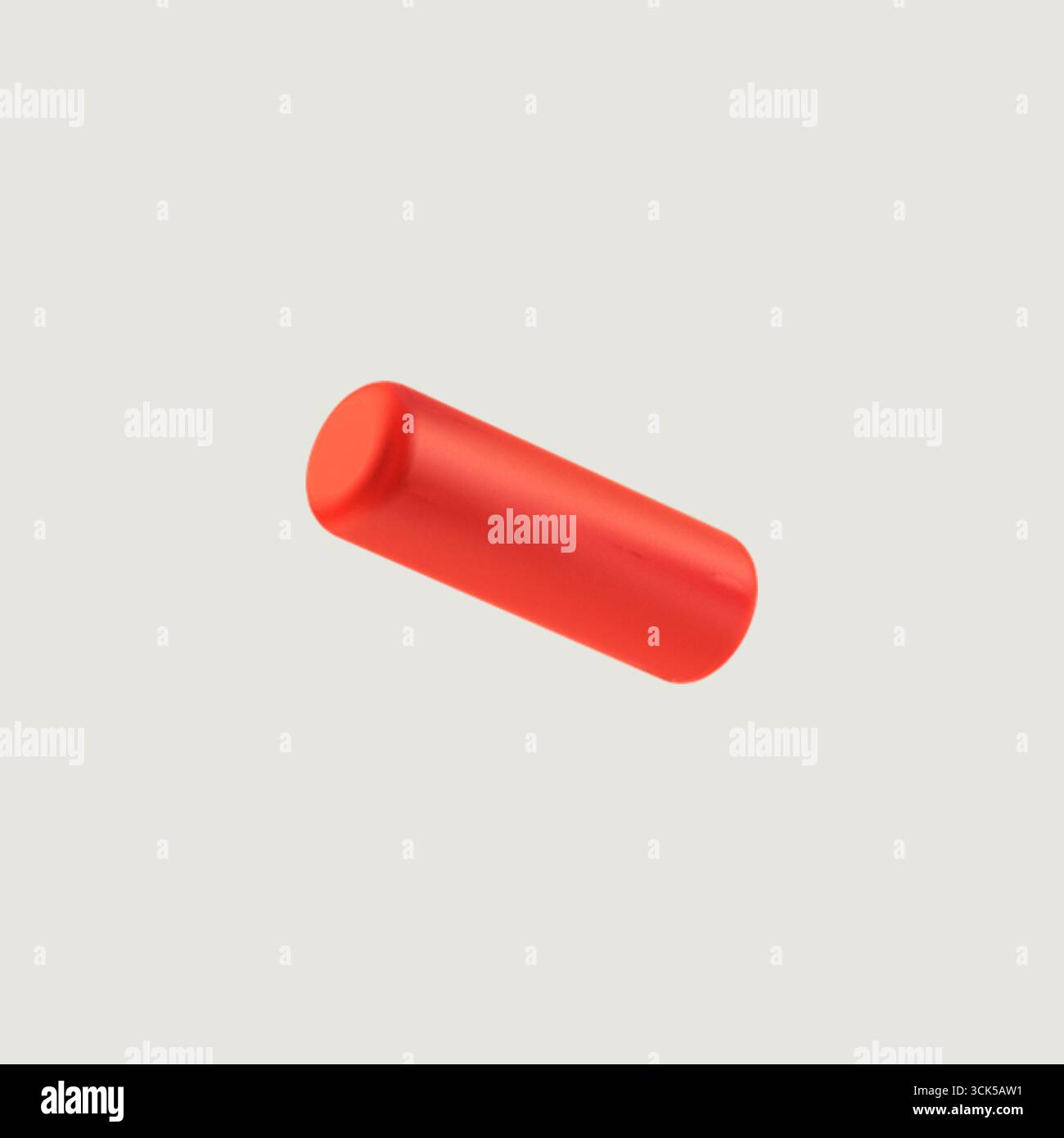 Un objet rouge lisse et cylindrique, peut-être un jouet ou un morceau de design graphique. Banque D'Images