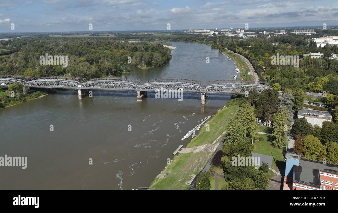 Vue panoramique par drone de Crémone Lombardie montrant le fleuve po un vaste paysage verdoyant avec un pont rempli de gens et illustr lointain étalement urbain Banque D'Images