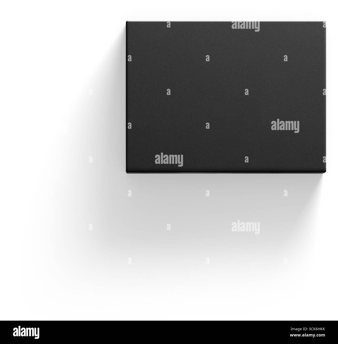 Une boîte noire épurée et minimaliste projetant une ombre douce, suggérant une esthétique de design moderne. Banque D'Images