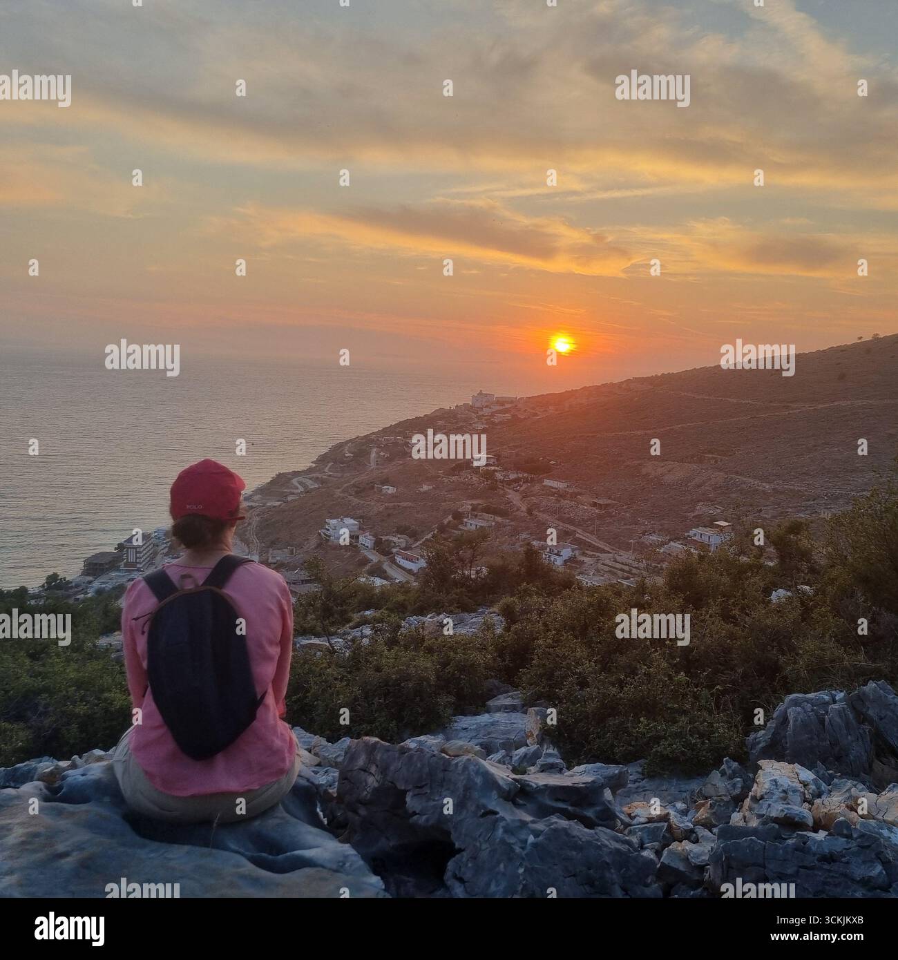 Femme sur une colline regardant le coucher de soleil à Sarande Albanie - Image de stock capturée avec un smartphone