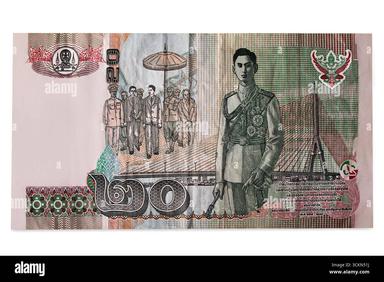 Un billet de banque thaïlandais de vingt bahts à l'image du roi thaïlandais sur un tissu écossais vert. Banque D'Images
