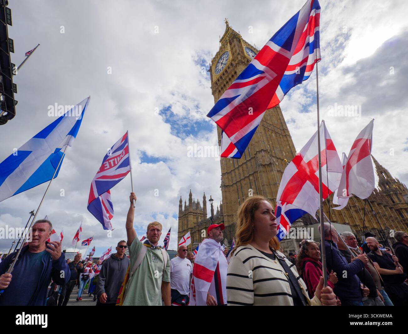 Manifestation unite the Kingdom, 13 septembre 2025, Westminster, Londres, Royaume-Uni. Des manifestants arborant les drapeaux de l'Union Jack et de St George défilent dans le centre de Londres devant Big Ben Westminster lors d'une manifestation organisée par Tommy Robinson Banque D'Images