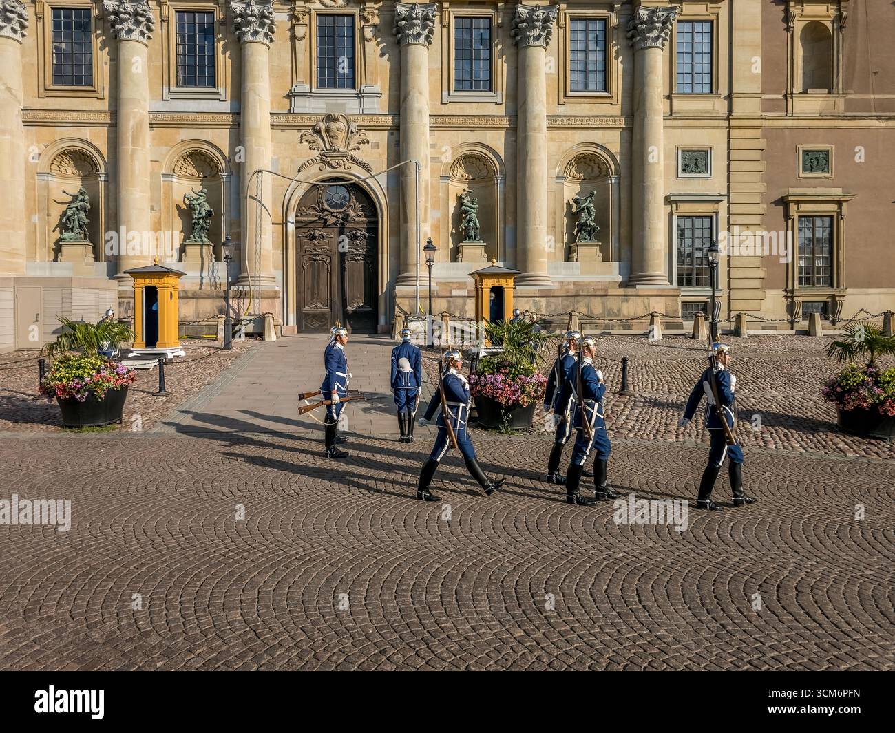 Des soldats royaux suédois en uniforme de tuniques bleues et des casques argentés changent de garde devant le Palais Royal de Stockholm en Suède Banque D'Images