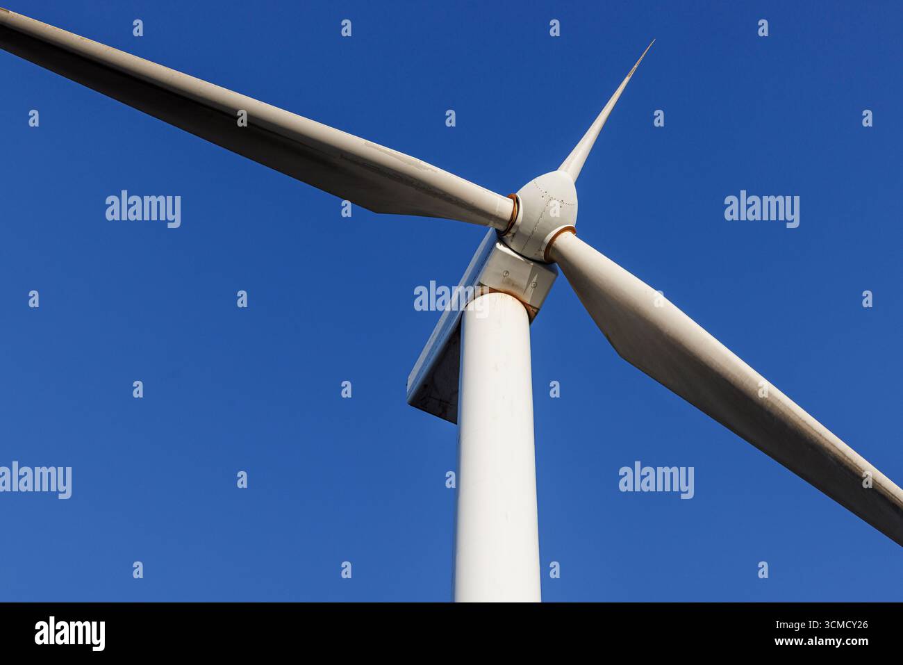 Vue rapprochée d'une éolienne moderne contre un ciel bleu clair. Technologie des énergies renouvelables et concept de production durable d'électricité. Banque D'Images Vue rapprochée d'une éolienne moderne contre un ciel bleu clair. Technologie des énergies renouvelables et concept de production durable d'électricité. Banque D'Images