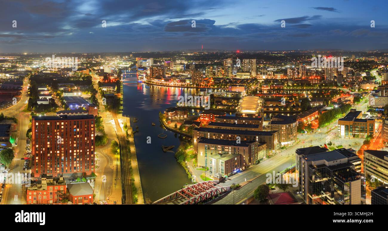 Vue aérienne au crépuscule de Salford Quays et de la rivière Irwell à Manchester avec les lumières de la ville brillantes reflétant sur l'eau. Banque D'Images