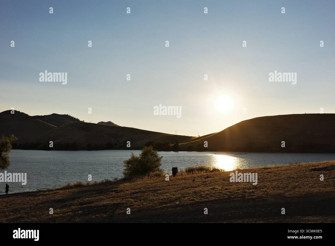 Coucher de soleil sur le réservoir Contra Loma à Antioch, Californie, qui fait partie du quartier du parc régional d'East Bay. La lumière dorée se reflète sur l'eau. Banque D'Images