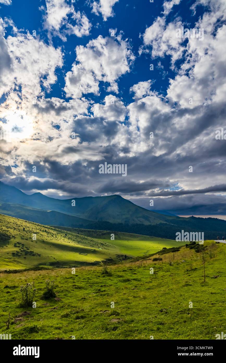 Beau paysage montrant le soleil briller à travers les nuages sur les collines verdoyantes et les vallées dans les montagnes des Pyrénées, près d'Ancizan, France Banque D'Images