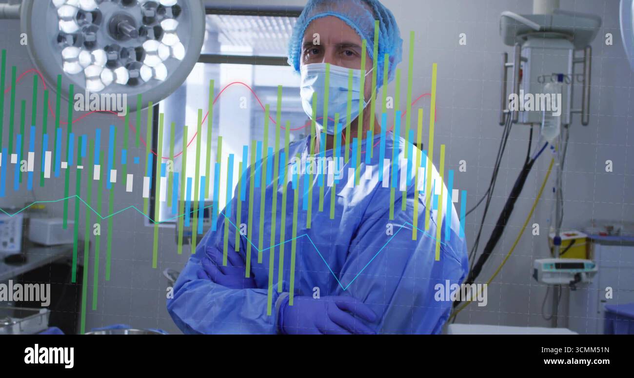 Chirurgien debout en gommage préparant la chirurgie en salle d'opération avec lumières chirurgicales et graphiques de données Banque D'Images