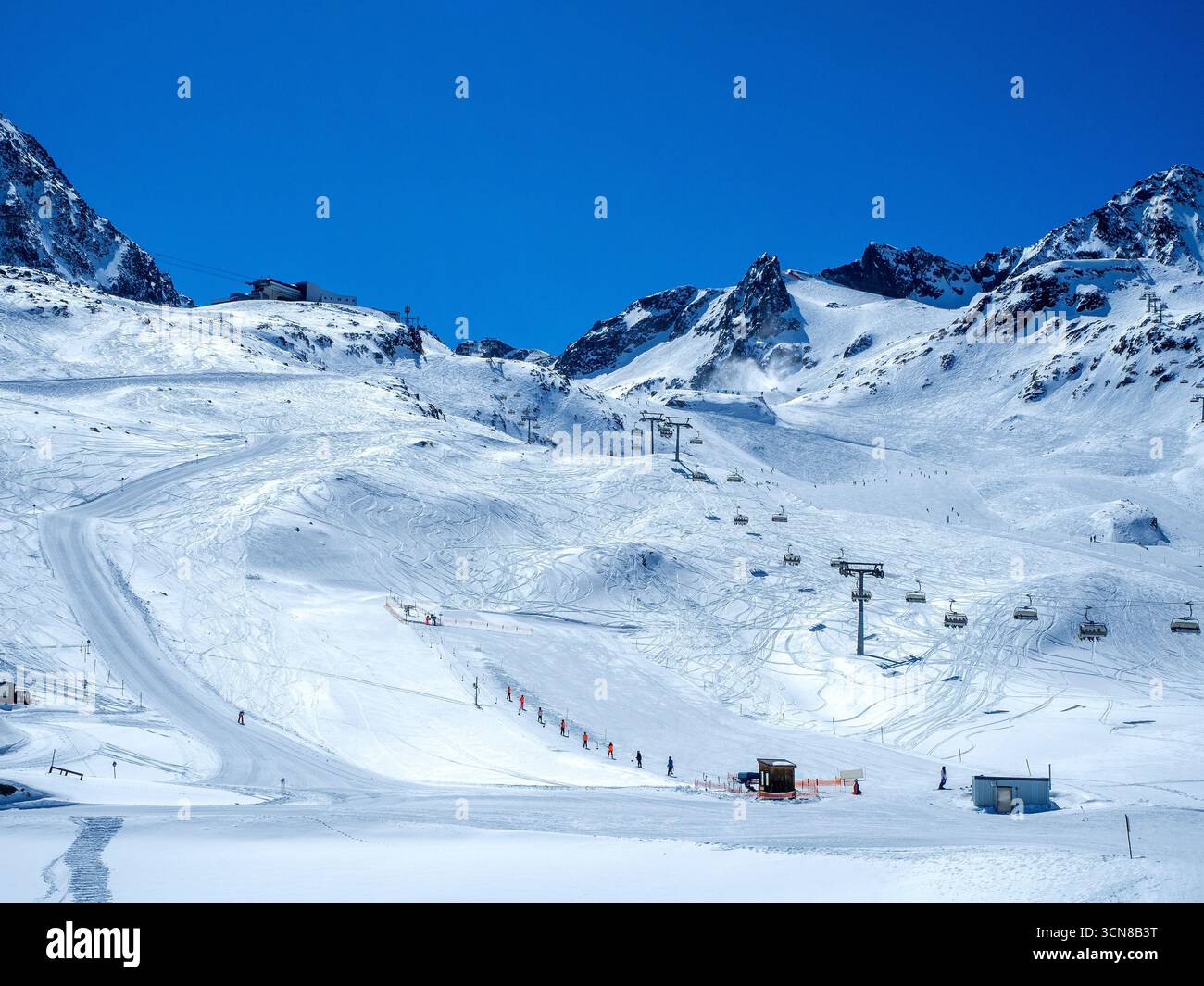 Glacier de Stubai dans les Alpes autrichiennes avec pistes de ski, télésièges, télésiège, téléphérique, skieurs et snowboarders. Ciel bleu avec espace de copie Banque D'Images