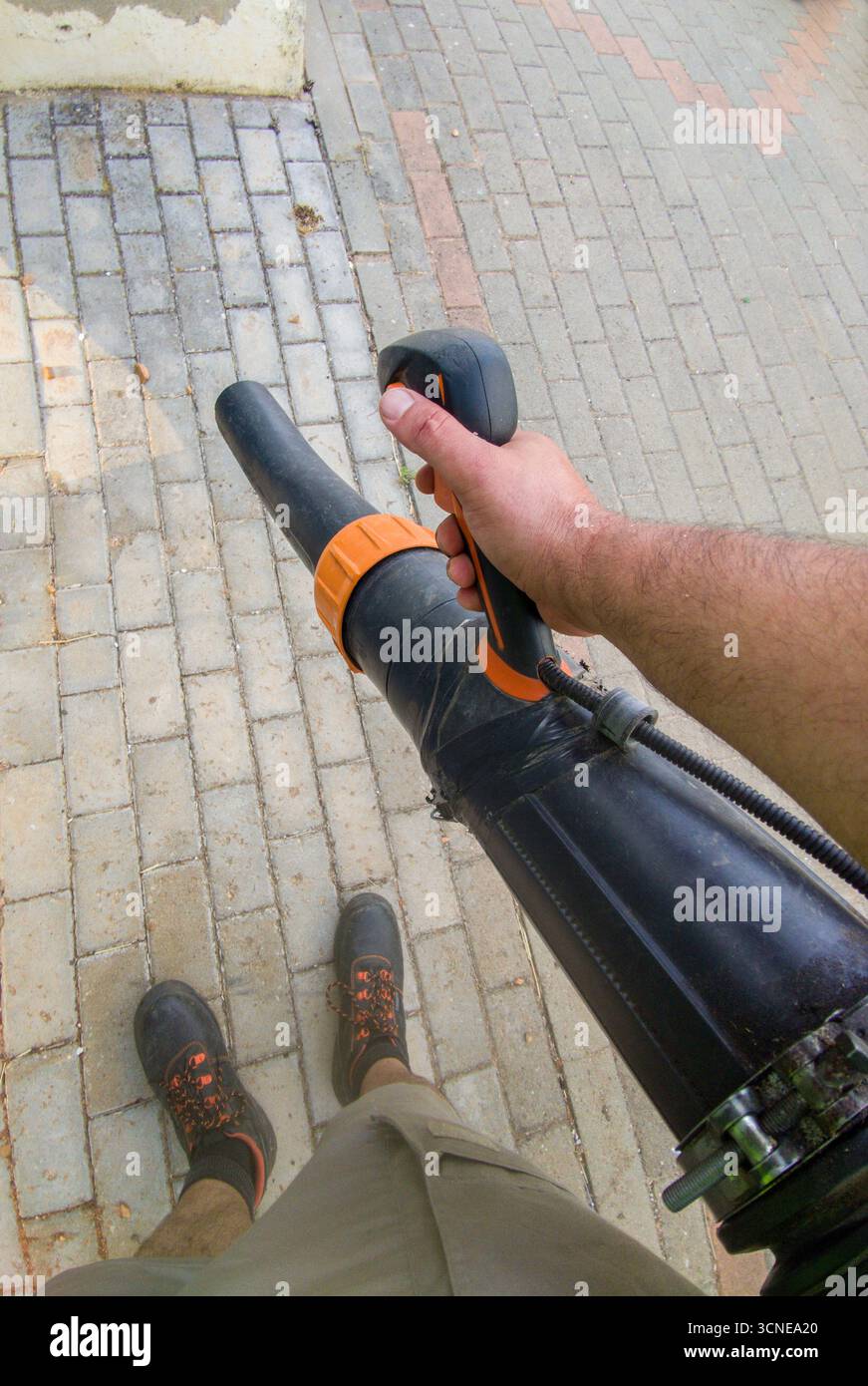 Souffleur de feuilles avec sac à dos moteur essence en action. EQUIPEMENT moteur pour travaux de jardinage propres Banque D'Images