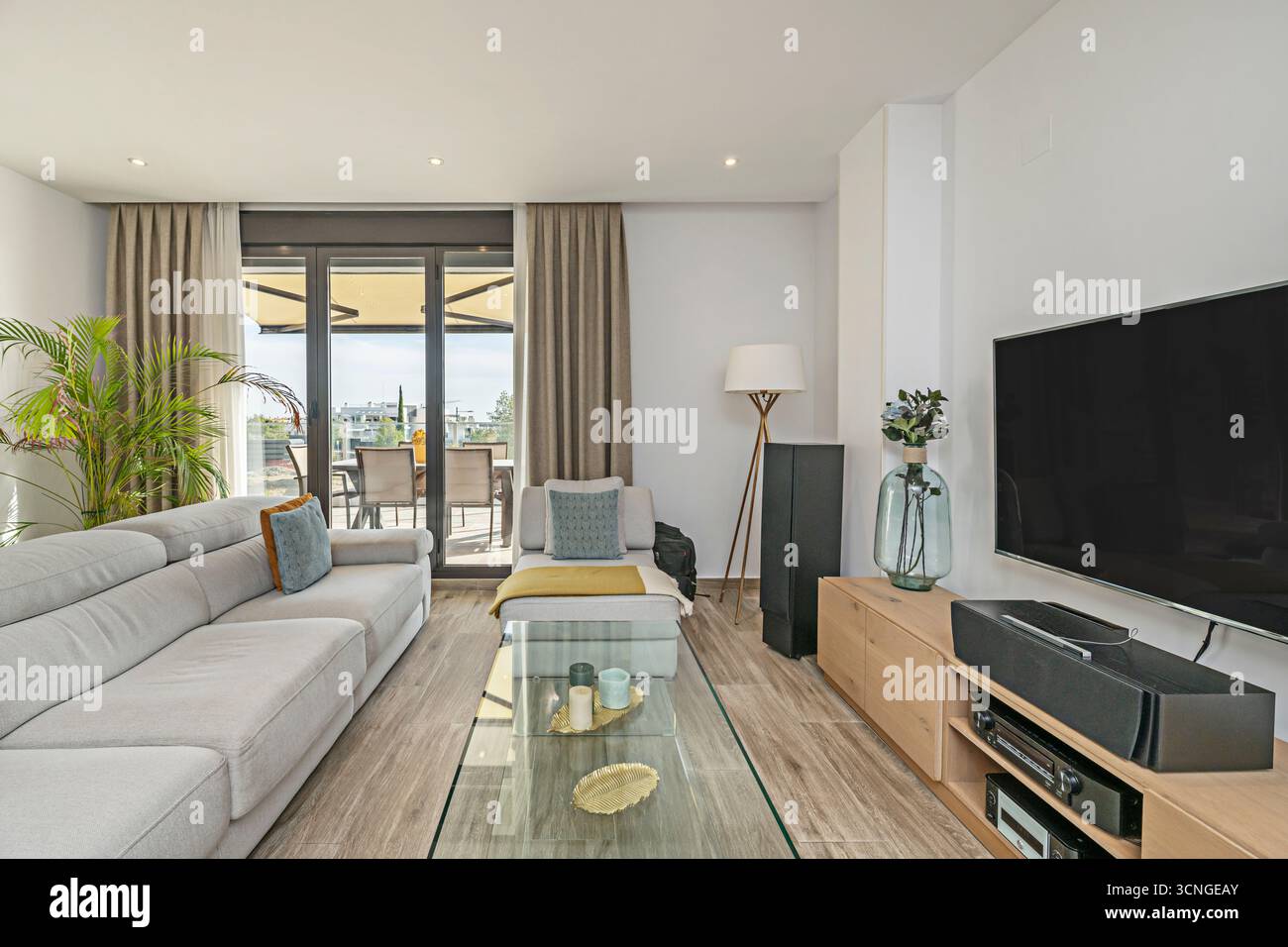 Style du milieu du siècle : canapé aux lignes épurées, table basse en bois sombre et chaises de salle à manger de style années 50 Banque D'Images