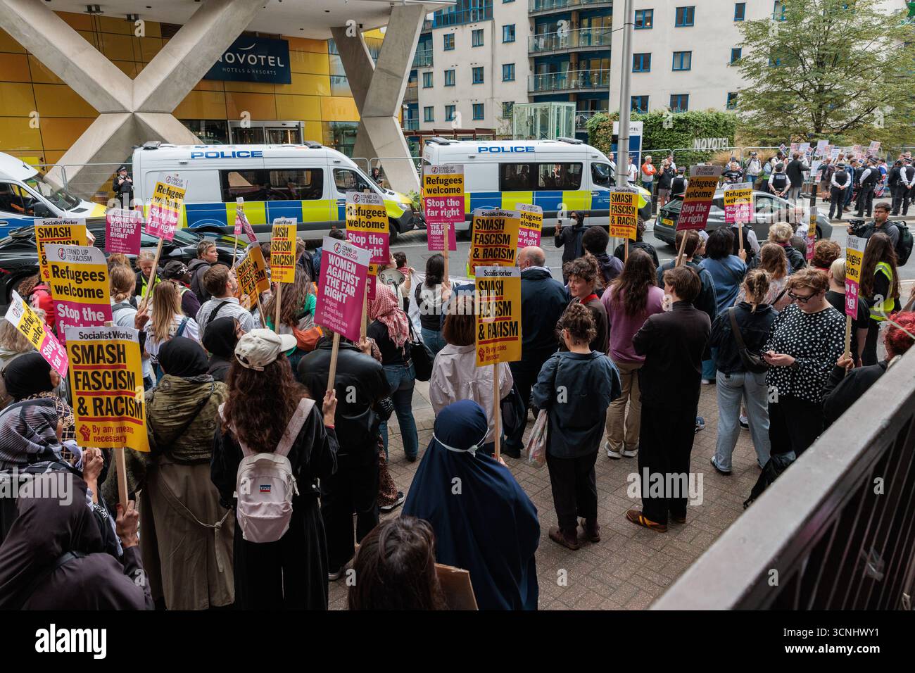 Londres, Royaume-Uni. 20 septembre 2025. Des partisans de Stand Up to Racism Holding pancartes assistent à une manifestation en défense des demandeurs d'asile devant l'hôtel Britannia à Canary Wharf. L'hôtel Britannia est devenu un point focal pour les manifestations de groupes soutenant et opposant les demandeurs d'asile après que le ministère de l'intérieur a commencé à le réaffecter comme logement pour les demandeurs d'asile en juillet. Crédit : Mark Kerrison/Alamy Live News Banque D'Images