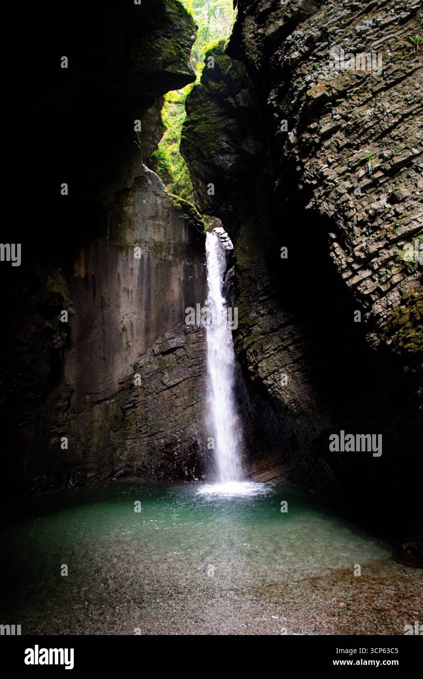 Kozjak Cascade près de Kobarid, Slovénie, cachée dans une grotte rocheuse avec piscine vert émeraude, monument naturel et destination de voyage populaire dans Triglav NP Banque D'Images