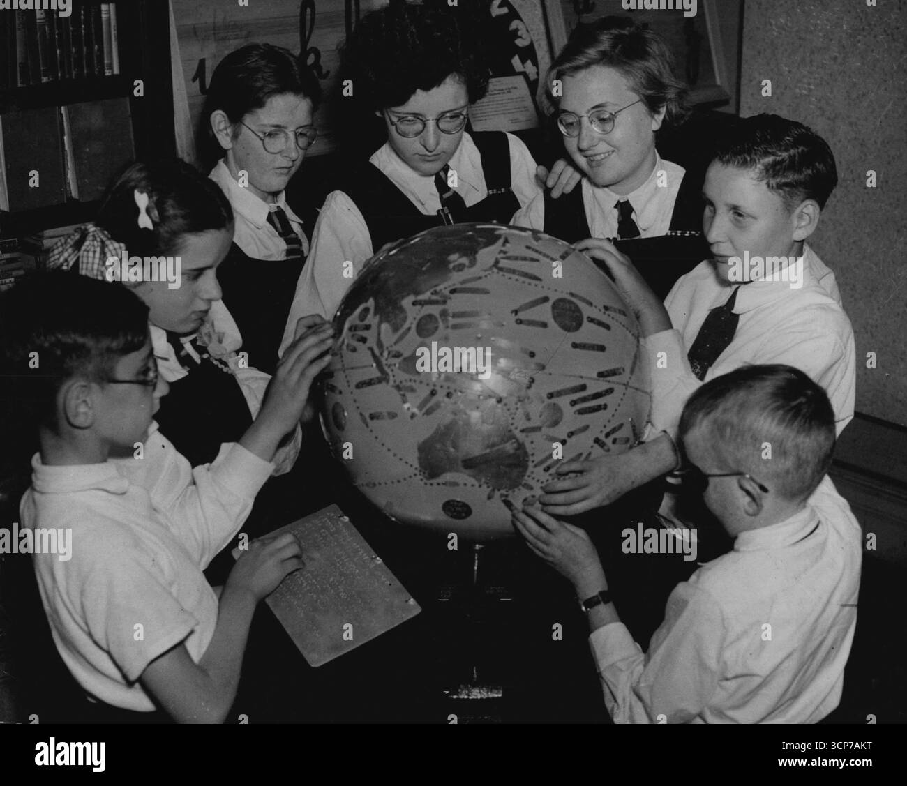 Leçons. Les enfants apprennent la géographie par le toucher à partir d'un globe en relief. La mère supérieure de l'école dit que les enfants apprennent vite ont souvent plus de concentration et de mémoire que les enfants normaux. 19 octobre 1949. Banque D'Images