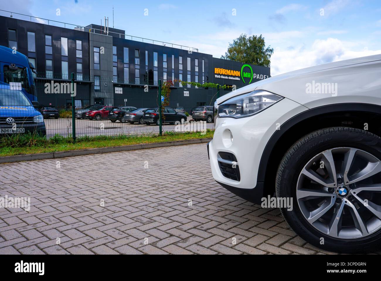 Gros plan du côté avant droit de la BMW X6 blanche près du bâtiment moderne Banque D'Images
