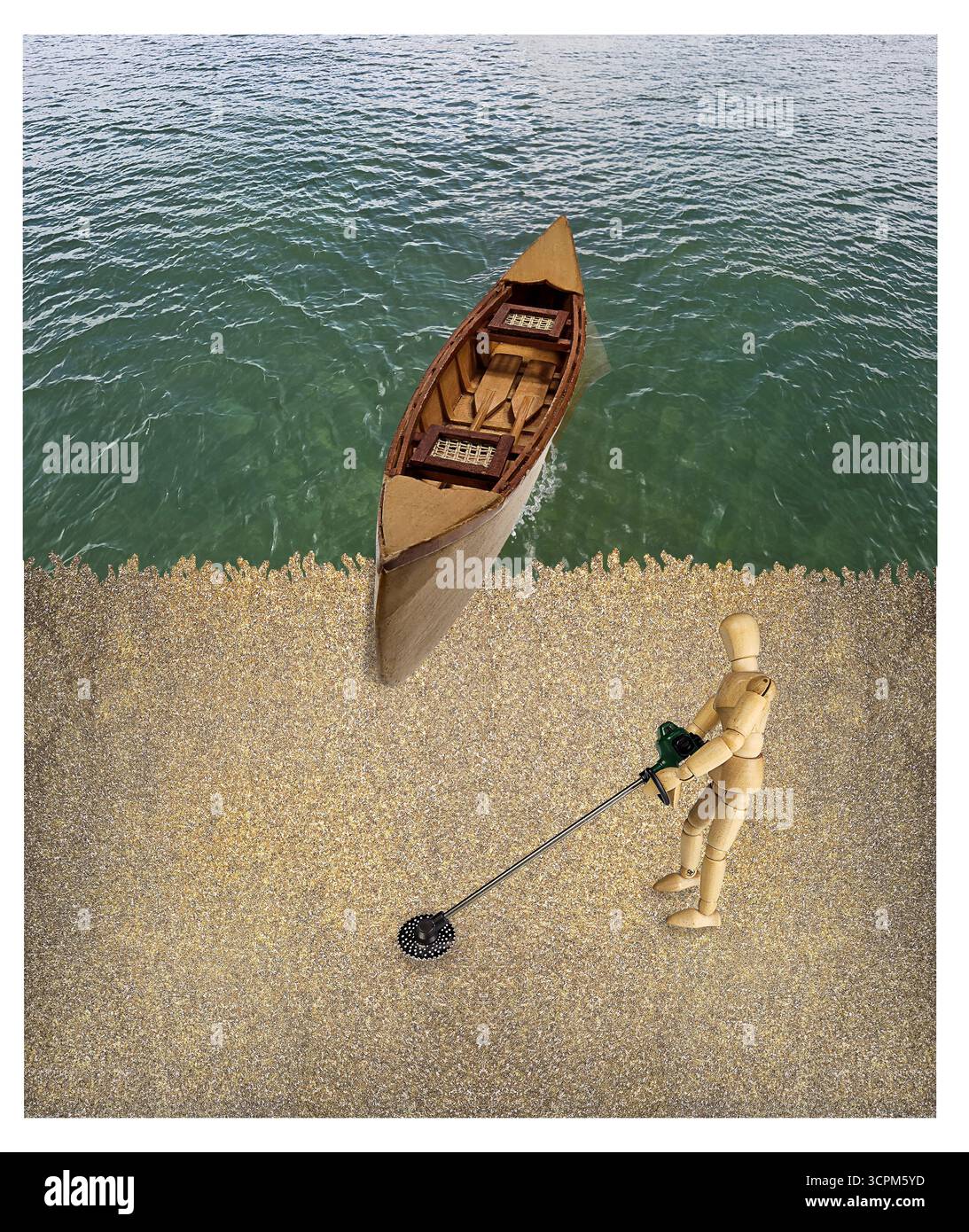 Utilisation d'un détecteur de métaux sur la plage au bord de l'eau avec un canoë Banque D'Images