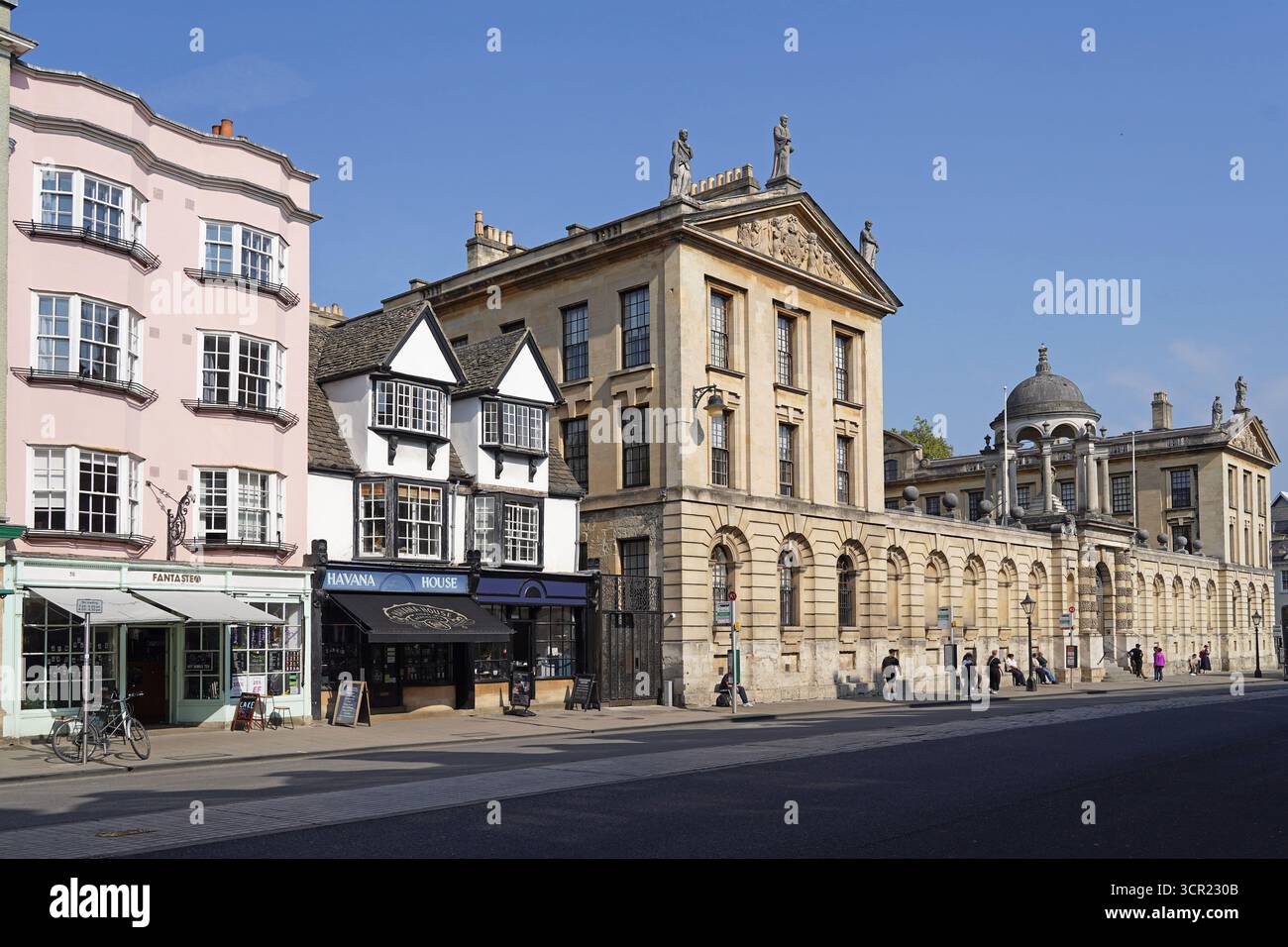 Oxford High Street, avec de vieux bâtiments commerciaux et la façade du Queen's College Banque D'Images