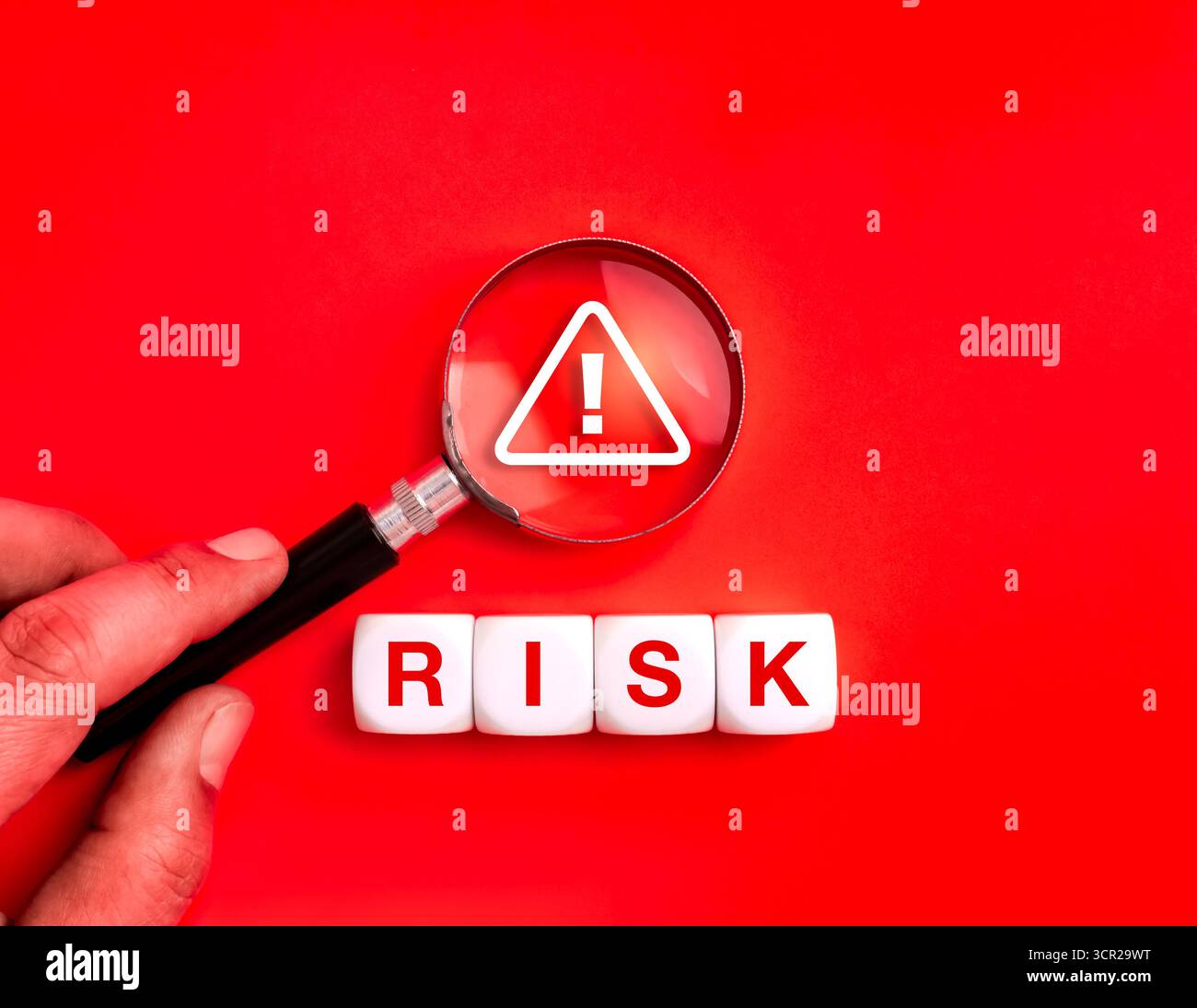 Loupe mettant l'accent sur le panneau d'avertissement et le mot RISQUE sur fond rouge. Concept de cybersécurité, protection des données, alerte escroquerie en ligne, détection de fraude Banque D'Images