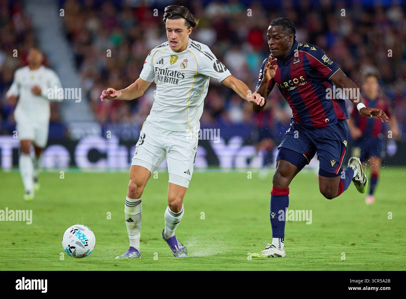 Valencia, Espagne. 23 septembre 2025. VALENCE, ESPAGNE - 23 SEPTEMBRE : L'arrière central Alvaro Carreras du Real Madrid concourt pour le ballon avec l'avant central Etta Eyong du Levante UD lors du match LaLiga EA Sports entre Levante UD et le Real Madrid au stade Ciutat de Valencia le 23 septembre 2025 à Valence, Espagne. (Photo de Jose Torres/photo Players images/Magara Press) crédit : Magara Press SL/Alamy Live News Banque D'Images