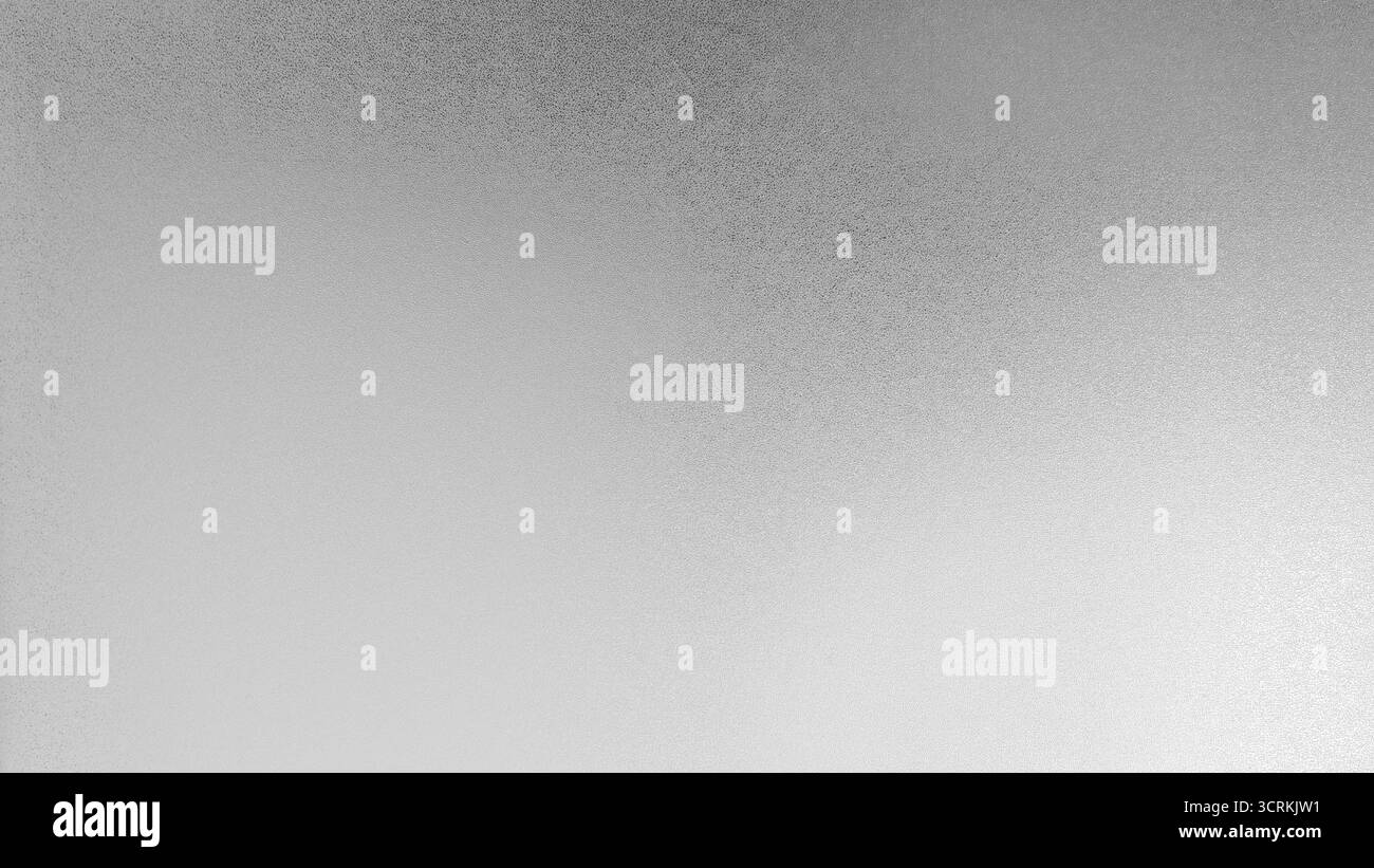 Gros plan sur la texture du verre dépoli gris clair. Dégradé subtil de surface, se déplaçant d'un blanc doux en bas à gauche légèrement gris plus foncé en haut à droite. Très bien Banque D'Images
