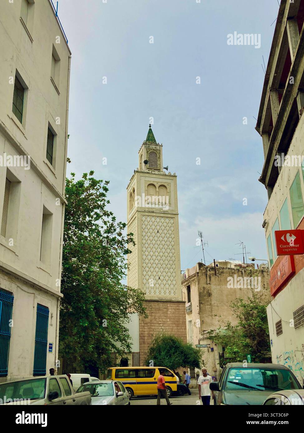 Vue sur la rue d'une mosquée dans le centre de Tunis, Tunisie. Minaret traditionnel, architecture urbaine et vie quotidienne dans la rue. Capturé le 22 septembre 2025. Banque D'Images
