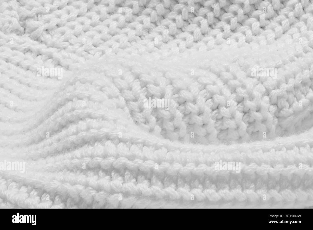 Un pull en tricot blanc avec un motif de fil blanc. Le pull est tricoté et a une texture douce Banque D'Images