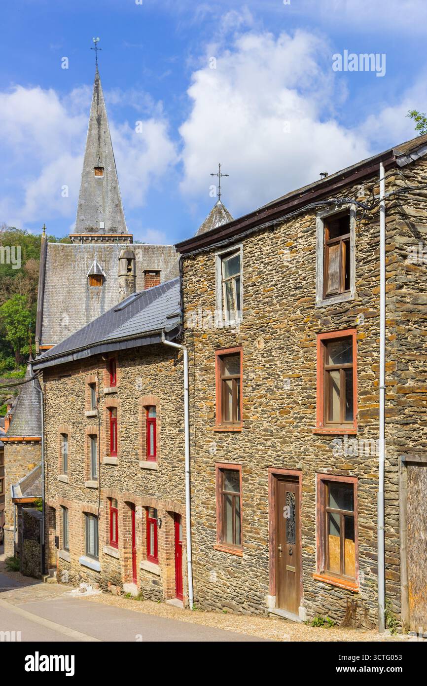 Vieilles maisons en pierre et église dans une rue escarpée de la Roche-en-Ardenne, Belgique Banque D'Images