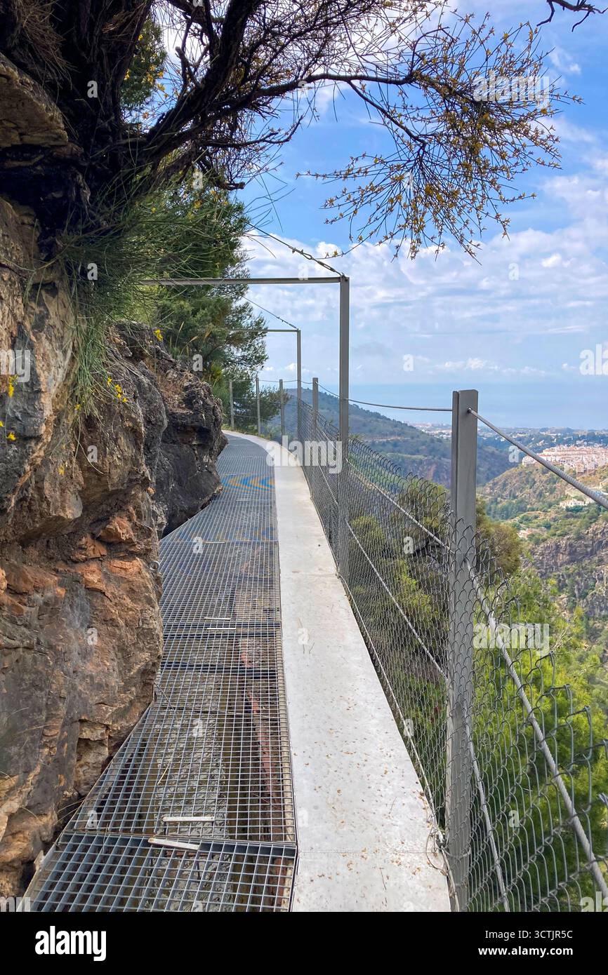 Vue panoramique sur les montagnes environnantes et village pittoresque depuis un sentier de randonnée le long d'un vieux fossé d'irrigation à Frigiliana, Espagne. Banque D'Images