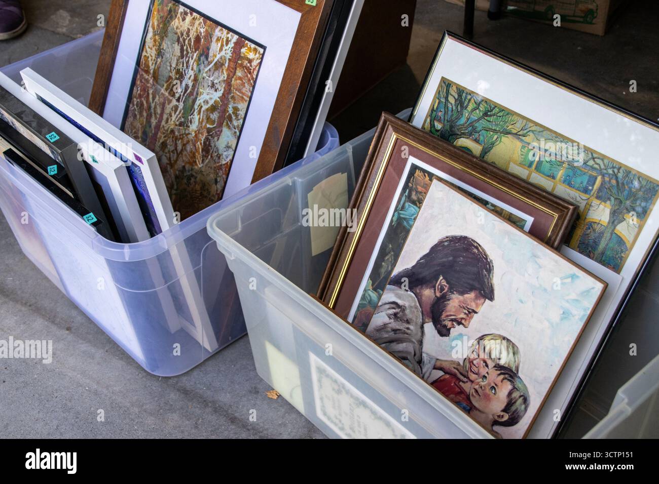 Photos dans des bacs en plastique à vendre à une vente de garage ou de cour dans une maison de banlieue dans le Midwest des États-Unis Banque D'Images