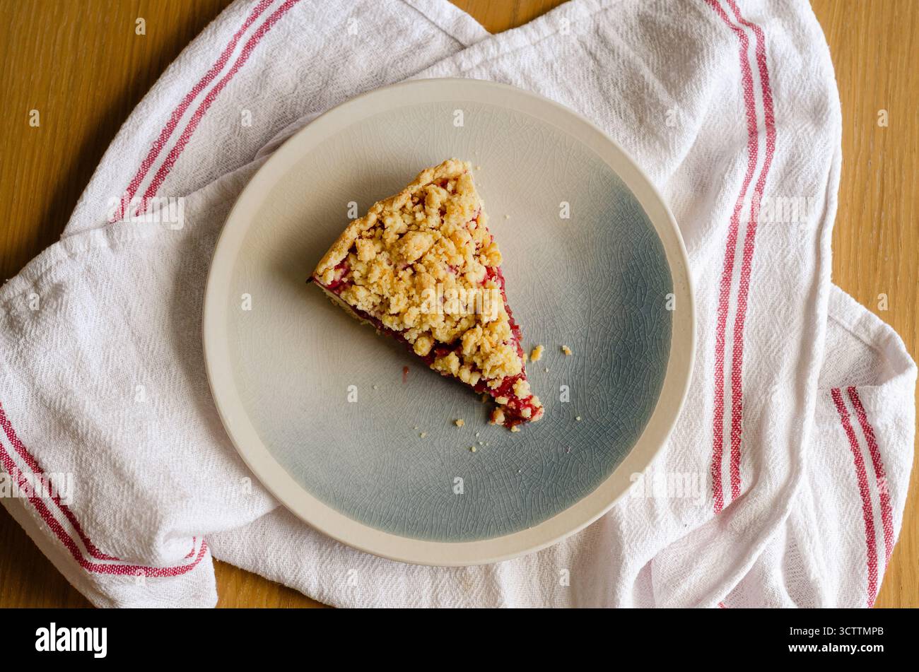 Vue de dessus de la tranche de tarte de crumble de sbriciolata avec confiture de prunes. Dessert rustique fait maison avec miettes au beurre. Parfait pour la cuisson d'automne et la saison de Noël Banque D'Images