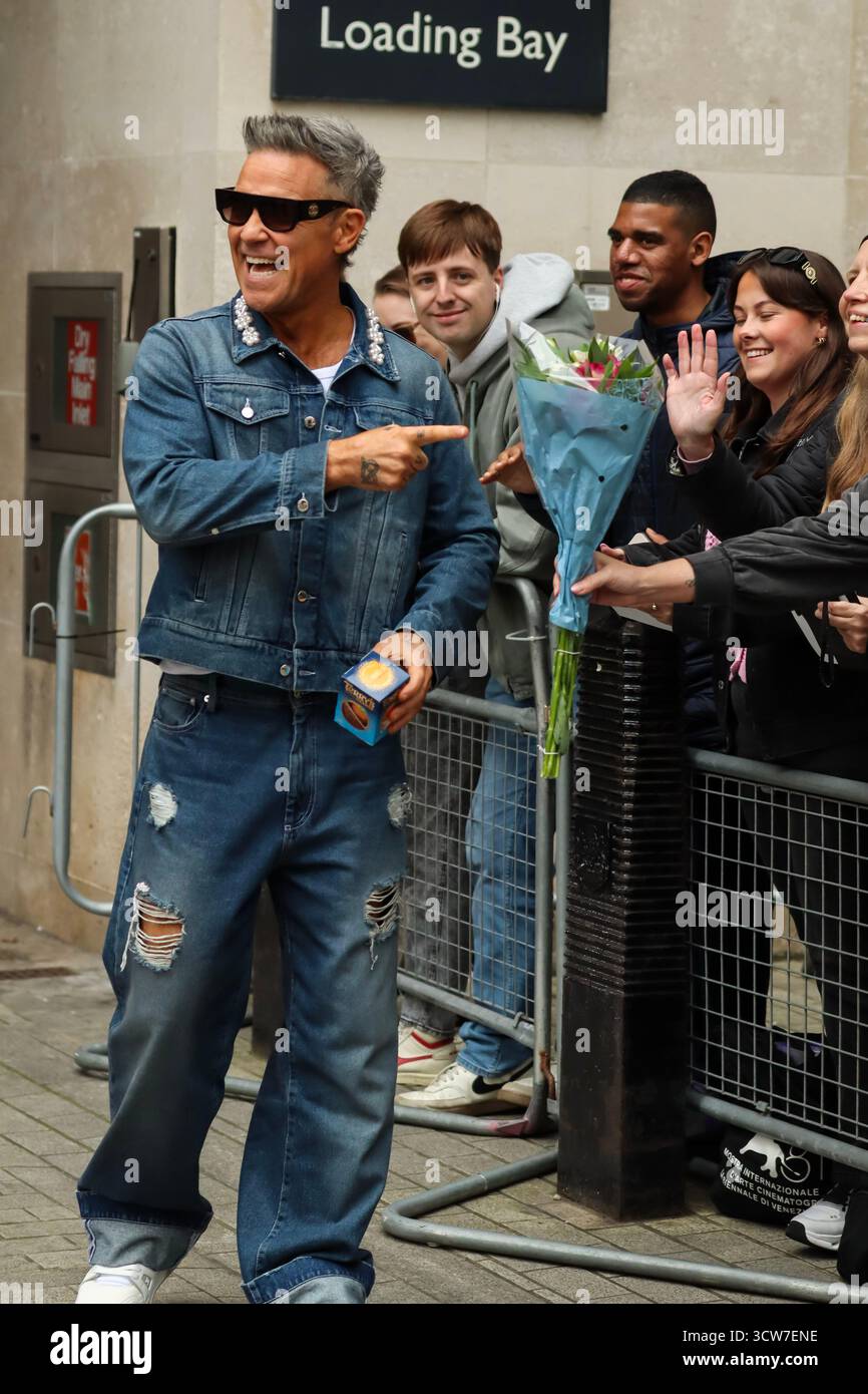 Londres, Royaume-Uni, 10 octobre 2025. Robbie Williams quitte la BBC et prend des vidéos avec des fans après être apparu sur BBC Radio 1 Live Lounge. Crédit : Ben Shaw/Alamy Live News Banque D'Images