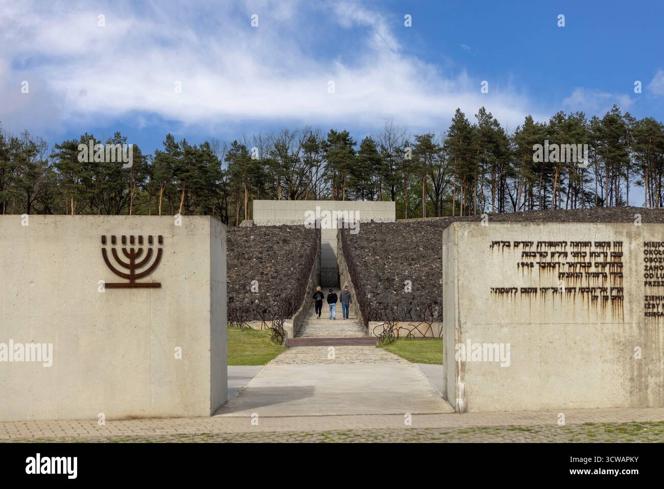 Belzec, Pologne - 29 avril 2025 : Musée et Mémorial à Belzec, camp d'extermination nazi. Mur avec menorah de fer et Death Road (crevasse) throu Banque D'Images